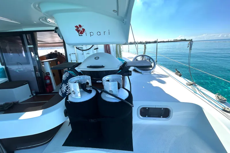Imany Yacht Photos Pics 2012 Fountaine Pajot Lipari catamaran deck with grill, ocean view, and clear skies.