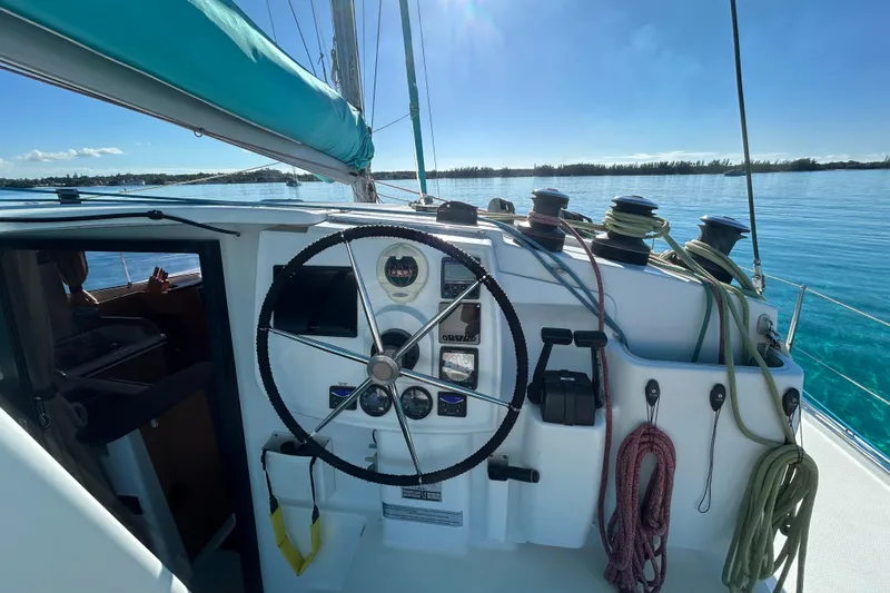 Imany Yacht Photos Pics Helm of 2012 Fountaine Pajot Lipari catamaran with ropes and clear ocean view.