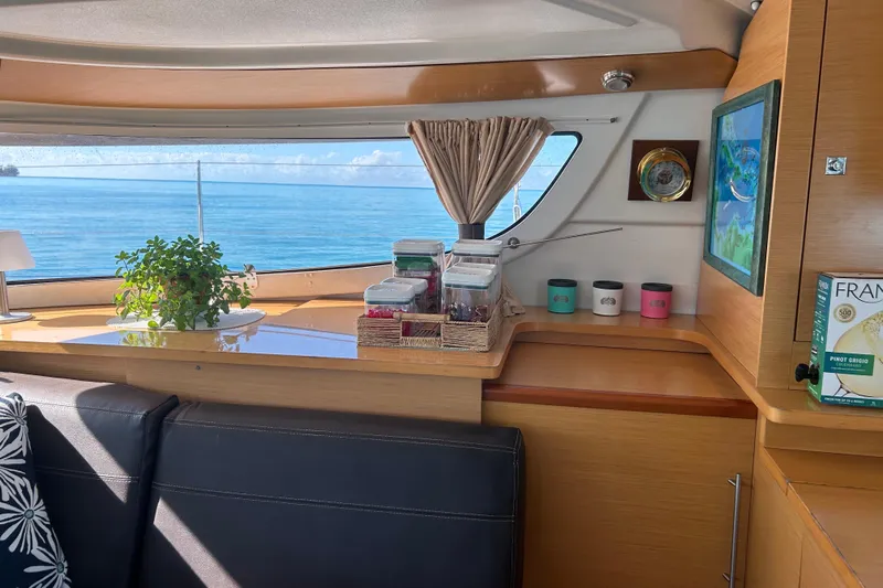 Imany Yacht Photos Pics Interior of 2012 Fountaine Pajot Lipari catamaran with ocean view and cozy decor.