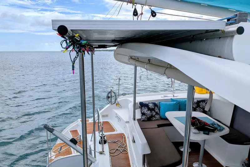 Imany Yacht Photos Pics 2012 Fountaine Pajot Lipari catamaran with deck seating, ocean view, and colorful decorations.