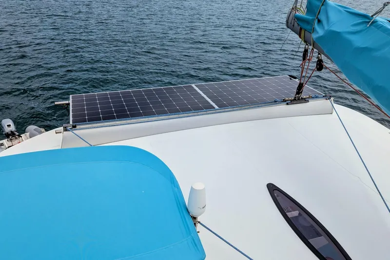 Imany Yacht Photos Pics 2012 Fountaine Pajot Lipari catamaran with solar panels on deck, sailing on open water.