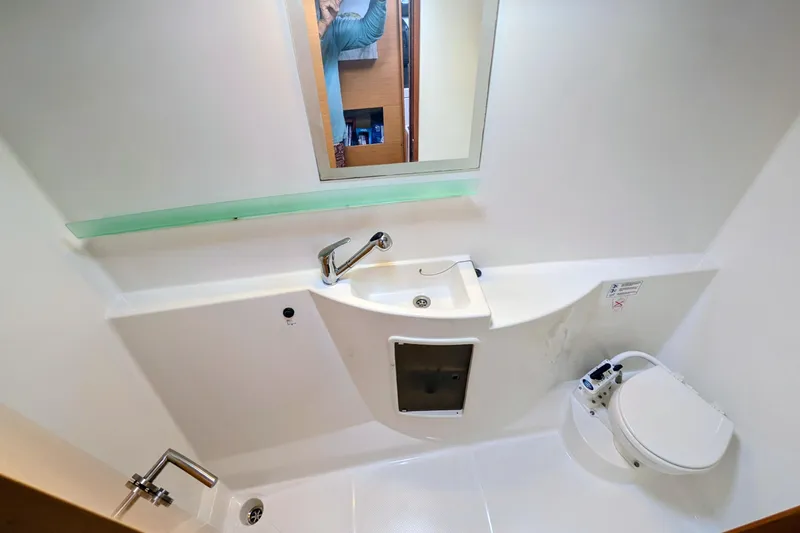 Imany Yacht Photos Pics Bathroom interior of 2012 Fountaine Pajot Lipari catamaran with sink and toilet.