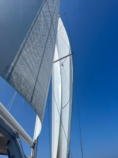  Yacht Photos Pics Sails of a 2013 Beneteau Sense 55 yacht against a clear blue sky.