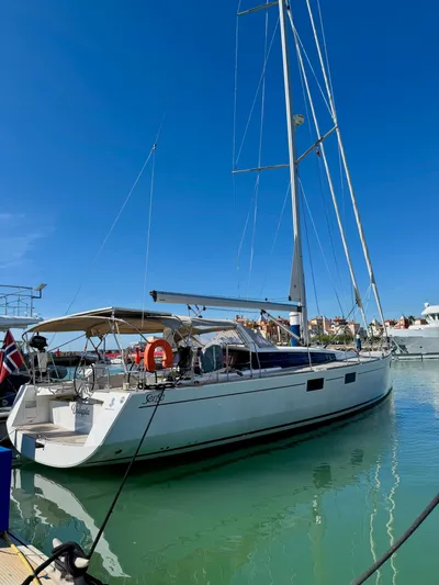  Yacht Photos Pics 2013 Beneteau Sense 55 yacht docked in a sunny marina.