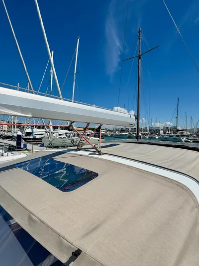  Yacht Photos Pics 2013 Beneteau Sense 55 sailboat docked in a marina under a clear blue sky.