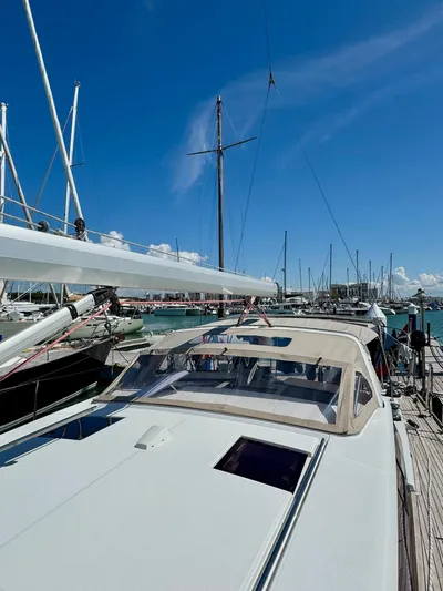  Yacht Photos Pics 2013 Beneteau Sense 55 yacht docked at marina under clear blue sky.