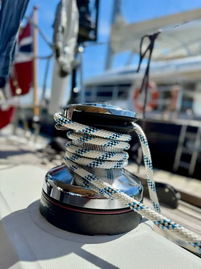  Yacht Photos Pics Close-up of a winch with rope on a 2013 Beneteau Sense 55 sailboat deck.