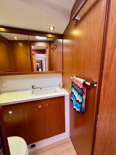  Yacht Photos Pics Luxurious bathroom in 2013 Beneteau Sense 55 yacht with wood cabinetry and modern fixtures.
