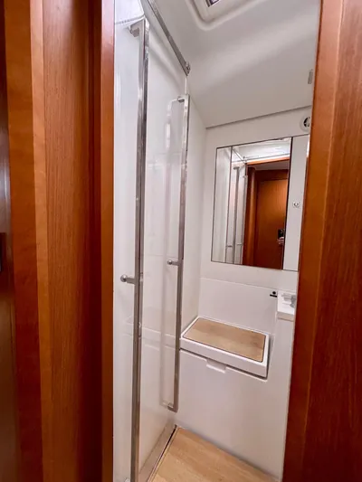  Yacht Photos Pics Shower area in 2013 Beneteau Sense 55 yacht with wooden accents and modern design.