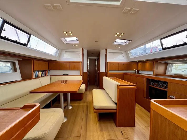  Yacht Photos Pics Luxurious interior of 2013 Beneteau Sense 55 yacht with elegant wood finishes and spacious seating.