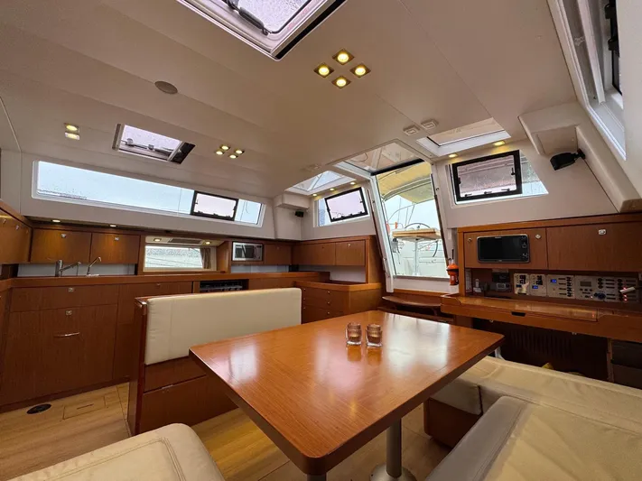  Yacht Photos Pics Luxurious interior of 2013 Beneteau Sense 55 yacht with modern kitchen and dining area.