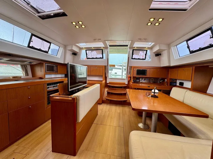  Yacht Photos Pics Luxurious interior of 2013 Beneteau Sense 55 yacht with modern furnishings and ample natural light.
