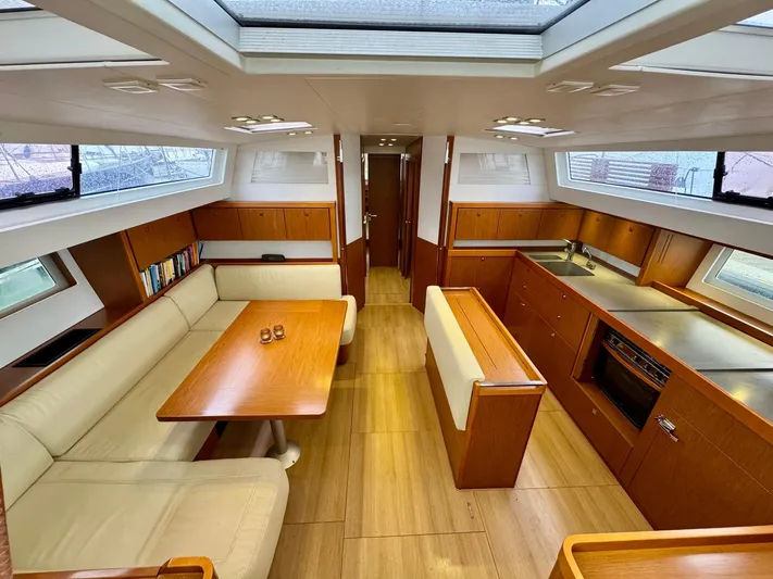  Yacht Photos Pics Luxurious interior of 2013 Beneteau Sense 55 yacht with spacious seating and modern kitchen.