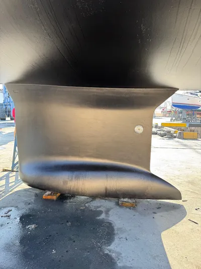  Yacht Photos Pics Close-up of 2013 Beneteau Sense 55 keel in dry dock, showcasing sleek design.