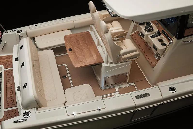  Yacht Photos Pics Manufacturer Provided Image: 2020 Chris-Craft Catalina 30 interior, featuring luxurious seating and a wooden table.