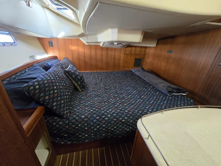 Scuba Duo Yacht Photos Pics Luxurious cabin interior of 2004 Hunter 41 AC yacht with cozy bedding and wood paneling.