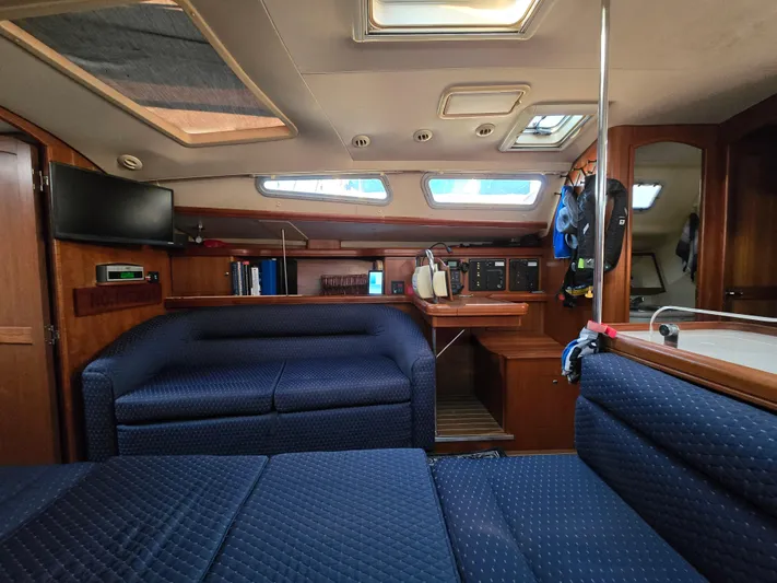 Scuba Duo Yacht Photos Pics Interior of a 2004 Hunter 41 AC sailboat with blue seating and wooden accents.