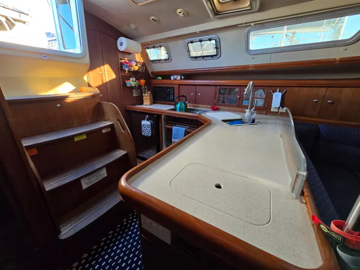 Scuba Duo Yacht Photos Pics Interior of 2004 Hunter 41 AC sailboat with modern kitchen and wooden cabinetry.