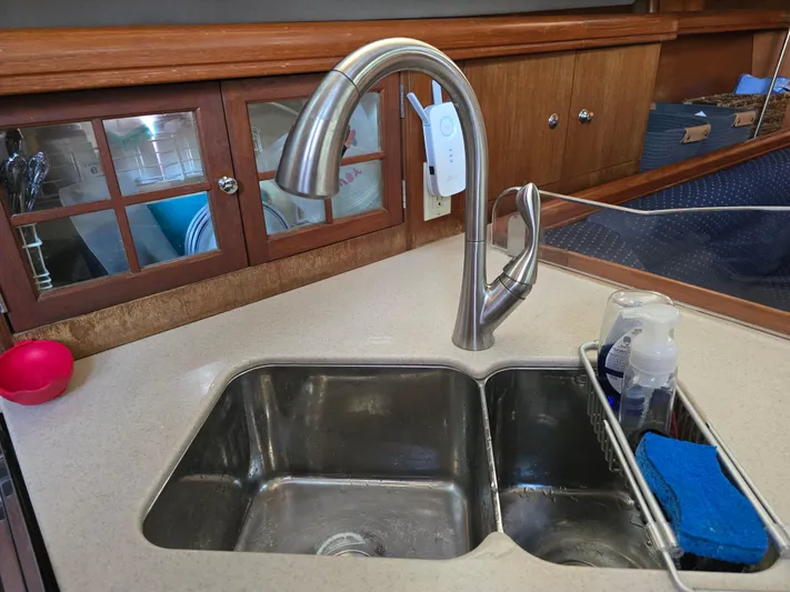 Scuba Duo Yacht Photos Pics Kitchen sink with modern faucet in a 2004 Hunter 41 AC yacht interior.