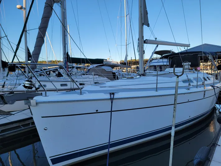 Scuba Duo Yacht Photos Pics 2004 Hunter 41 AC sailboat docked in a marina, showcasing sleek design and white hull.