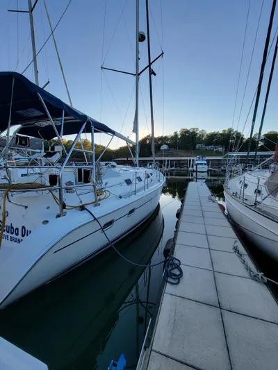 Scuba Duo Yacht Photos Pics 2004 Hunter 41 AC sailboat docked at marina, side view, calm water, clear sky.