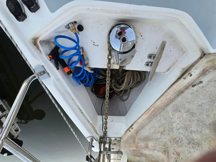 Scuba Duo Yacht Photos Pics Anchor locker of 2004 Hunter 41 AC sailboat with chain, ropes, and coiled hose.