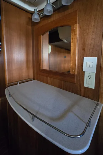Scuba Duo Yacht Photos Pics Wooden interior of a 2004 Hunter 41 AC yacht with a countertop and mirror.