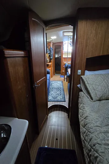 Scuba Duo Yacht Photos Pics Interior of 2004 Hunter 41 AC sailboat with wood paneling and cozy bedding.