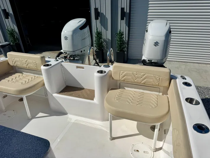  Yacht Photos Pics 2023 Twin Vee 280 GFX CC boat interior with beige seating and dual outboard engines.
