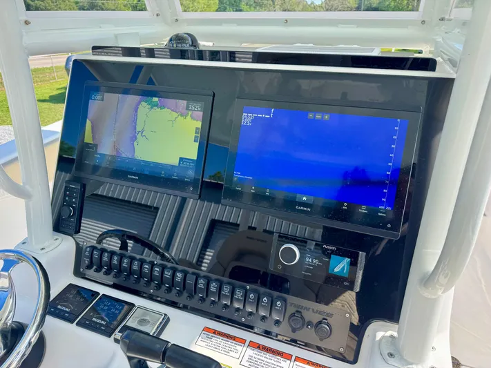  Yacht Photos Pics 2023 Twin Vee 280 GFX CC dashboard with dual navigation screens and control panel.