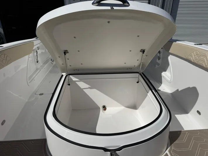  Yacht Photos Pics 2023 Twin Vee 280 GFX CC boat storage compartment open, showcasing spacious interior.