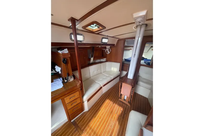 Spray Yacht Photos Pics Interior of 2002 Tartan 37 sailboat with wood accents and white seating.