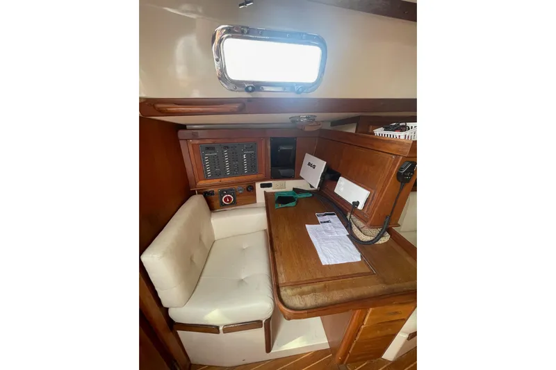 Spray Yacht Photos Pics 2002 Tartan 37 yacht interior with navigation station and seating area.