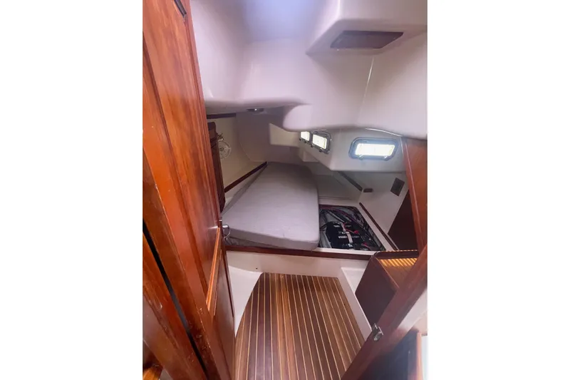 Spray Yacht Photos Pics Interior cabin of 2002 Tartan 37 sailboat with wooden flooring and cozy sleeping area.