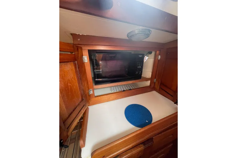 Spray Yacht Photos Pics 2002 Tartan 37 yacht interior with microwave and wooden cabinetry.