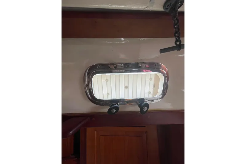 Spray Yacht Photos Pics Portlight window inside a 2002 Tartan 37 sailboat, featuring a polished metal frame.