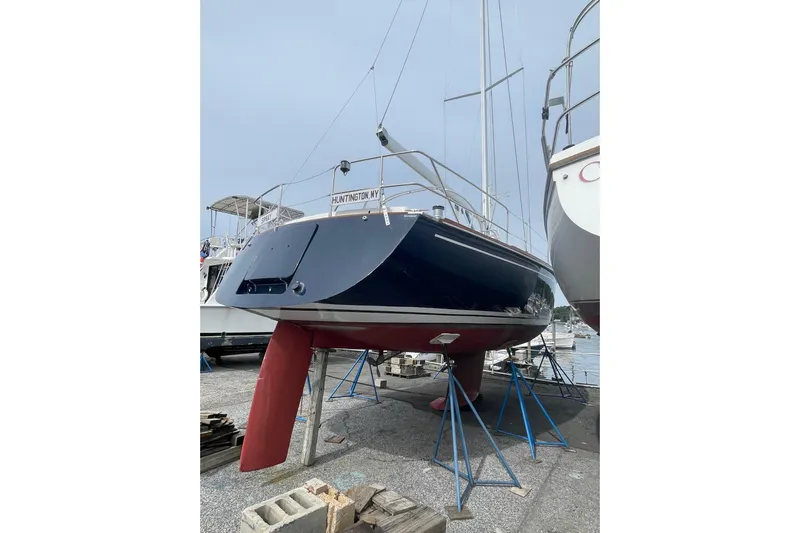 Spray Yacht Photos Pics Tartan 37 sailboat from 2002 on stands, displayed in a marina setting.