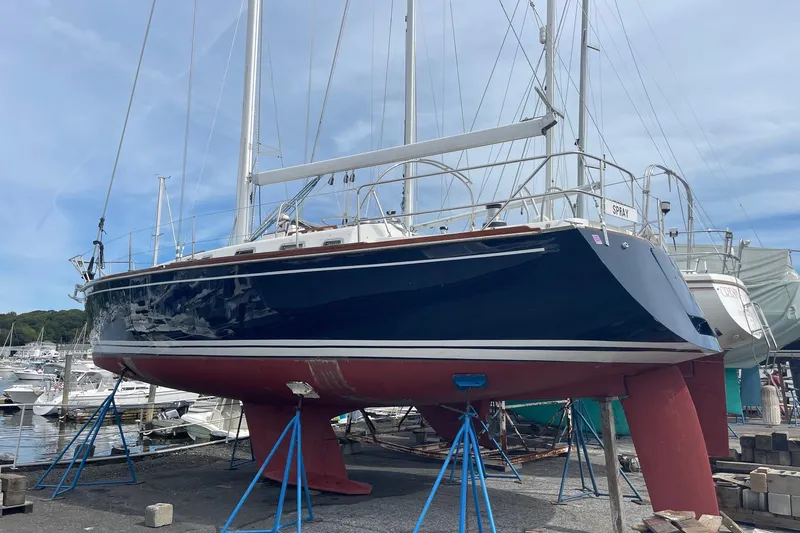 Spray Yacht Photos Pics 2002 Tartan 37 sailboat on stands in a marina, blue hull, red keel.