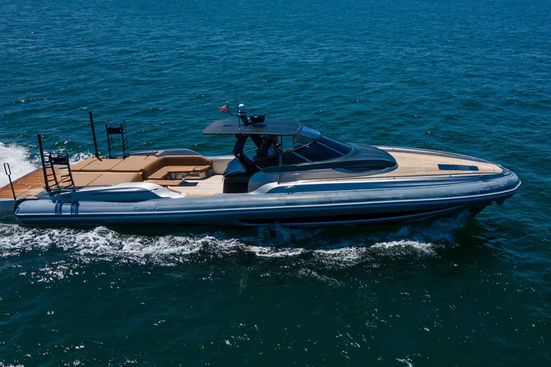 Quikwood Yacht Photos Pics 2014 SACS Strider boat cruising on open water, featuring sleek design and spacious deck.