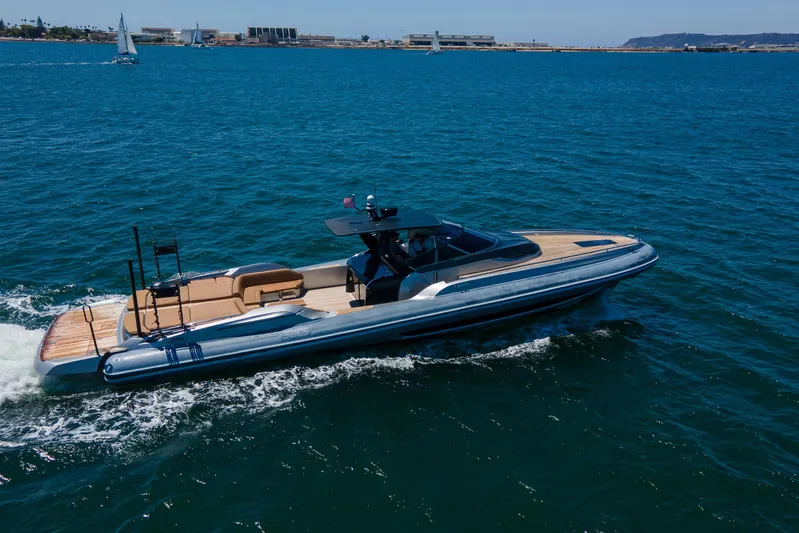 Quikwood Yacht Photos Pics 2014 SACS Strider yacht cruising on open water, with scenic coastal background.