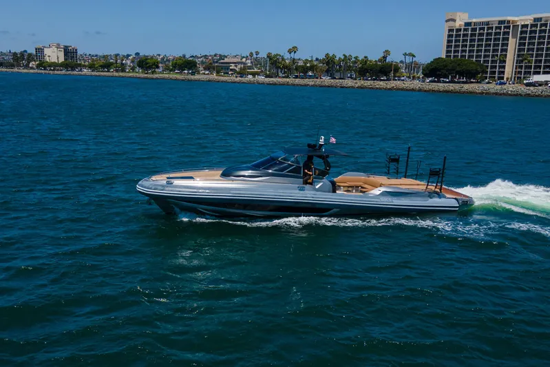 Quikwood Yacht Photos Pics 2014 SACS Strider yacht cruising on blue ocean near coastal cityscape.