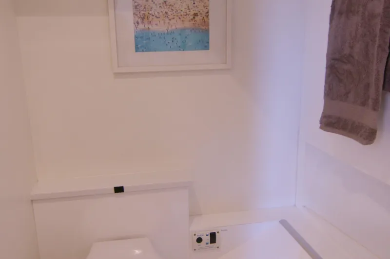 Quikwood Yacht Photos Pics Modern bathroom interior on 2014 SACS Strider yacht, featuring artwork and towel.