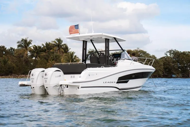 Yacht Photos Pics 2026 Jeanneau Leader 9.0 WA Series 2 boat on water, with American flag, tropical backdrop.
