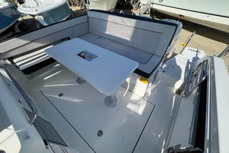  Yacht Photos Pics 2026 Jeanneau Leader 9.0 WA Series 2 boat interior with seating and table.