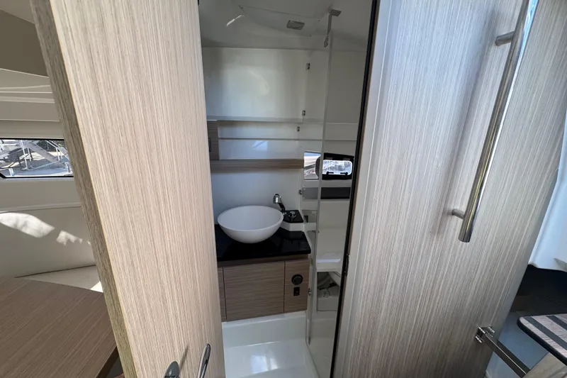  Yacht Photos Pics 2026 Jeanneau Leader 9.0 WA Series 2 bathroom with modern sink and wooden cabinetry.