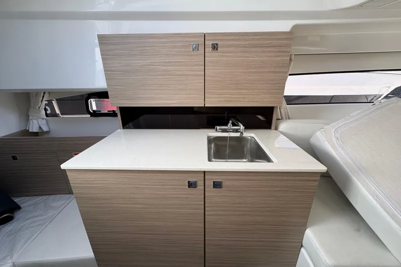  Yacht Photos Pics 2026 Jeanneau Leader 9.0 WA Series 2 interior with modern kitchenette and sink.