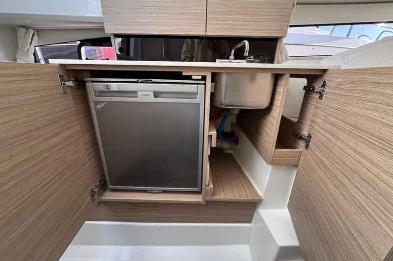 Yacht Photos Pics 2026 Jeanneau Leader 9.0 WA Series 2 boat interior kitchen with sink and fridge.
