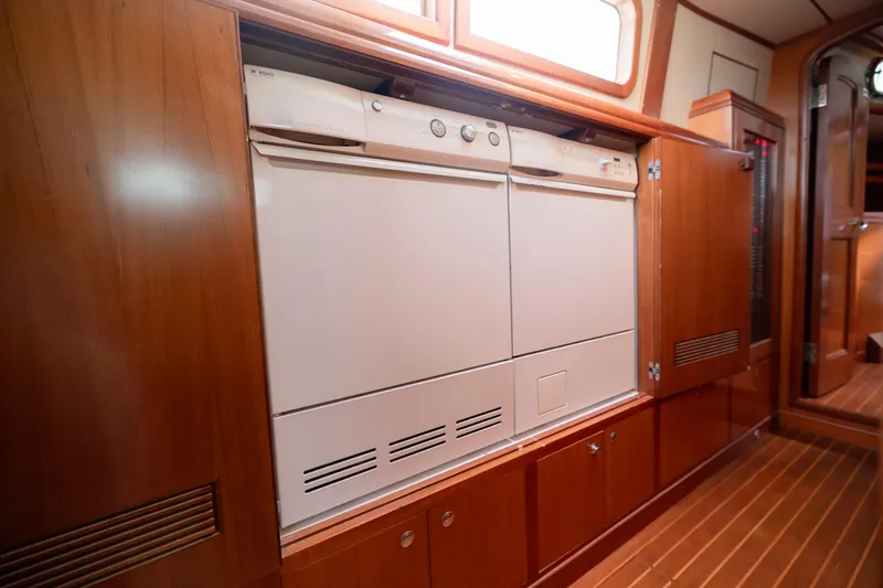  Yacht Photos Pics Interior of 2009 Nordhavn 56 Motorsailer with built-in appliances and wooden cabinetry.