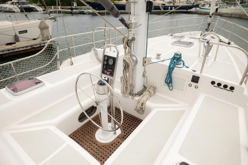  Yacht Photos Pics 2009 Nordhavn 56 Motorsailer cockpit with steering wheel and control panel, docked at marina.