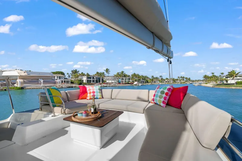 Halcyon Yacht Photos Pics Luxurious 2024 Fountaine Pajot Aura 51 Catamaran with colorful cushions and ocean view.